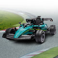 Kids riding a green Kahuna Aston Martin Aramco F1 licensed electric ride-on race car by Everything Baby.