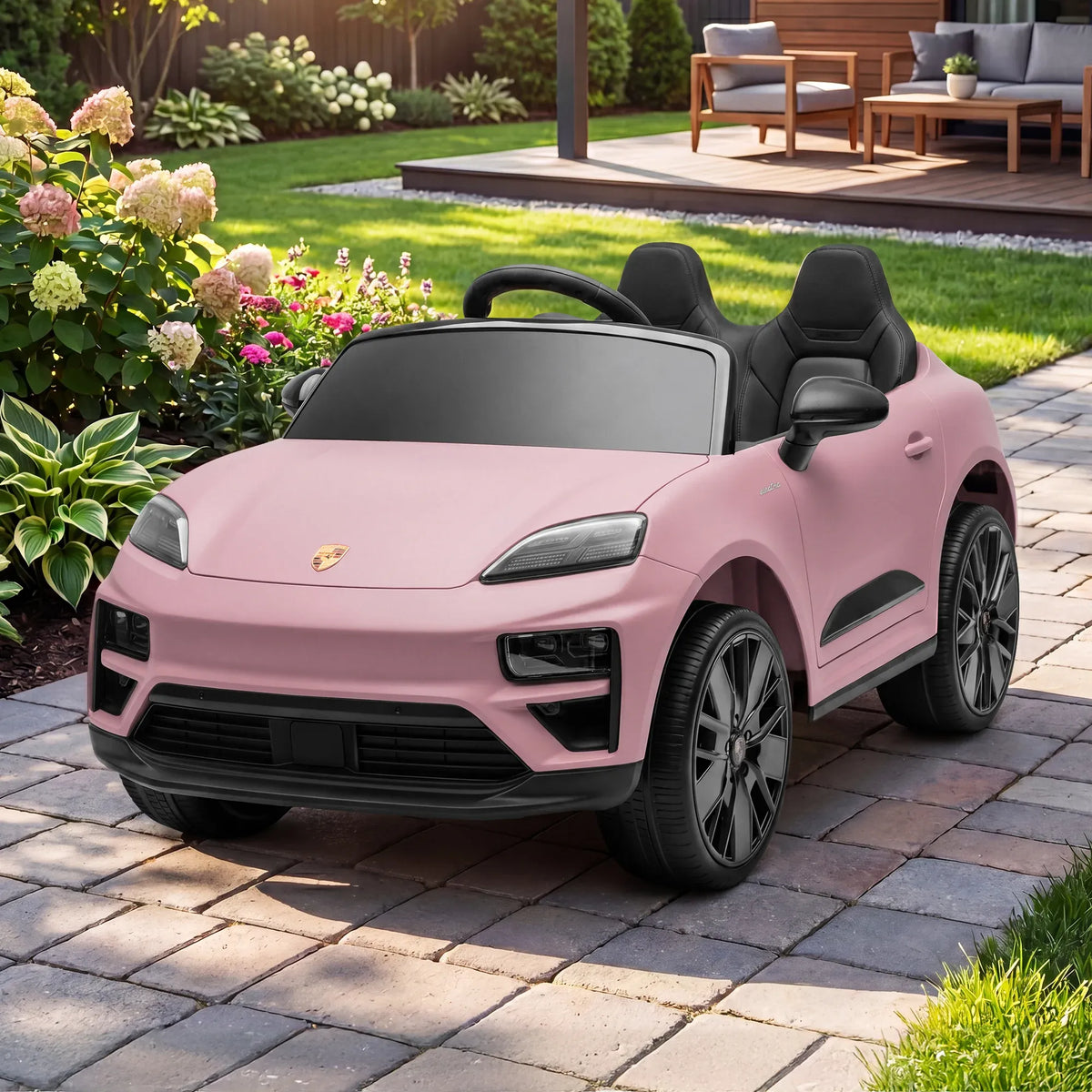 Pink Porsche Macan Turbo EV kids ride-on car with 12V electric motor, featuring realistic design and sporty details for children.