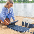 Blue waterproof picnic blanket from Everything Baby, perfect for outdoor meals with kids, featuring a soft, durable fabric.