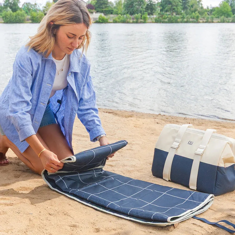 Blue waterproof picnic blanket from Everything Baby, perfect for outdoor meals with kids, featuring a soft, durable fabric.