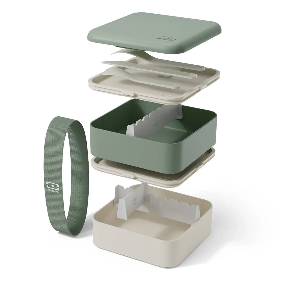 Green Monbento Flex kid's lunch box with two compartments and cutlery, designed for children, featuring a durable, eco-friendly design.