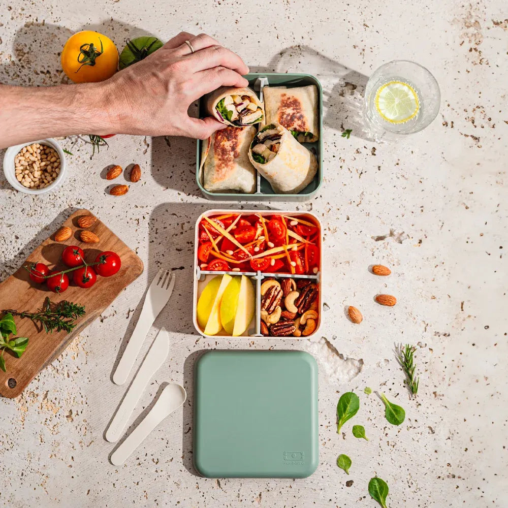 Green Monbento Flex kid's lunch box with two compartments and cutlery, designed for baby and kids' lunch storage.