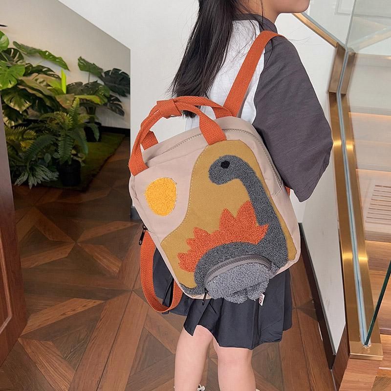 Khaki mini dinosaur backpack for kids, 21x10x26cm, featuring a cute dinosaur design for early learners and daily outings.