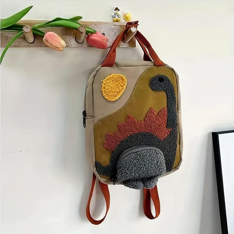 Khaki mini dinosaur backpack for kids, 21x10x26cm, with playful dinosaur design, ideal for early learners and daily outings.