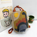 Khaki mini dinosaur backpack for kids, 21x10x26cm, with playful dinosaur design, perfect for early learners and daily outings.