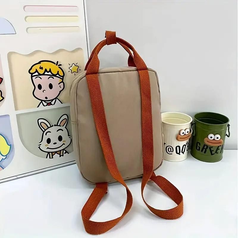 Khaki mini dinosaur backpack for kids, 21x10x26cm, featuring a playful dinosaur design, ideal for early learners and daily outings.