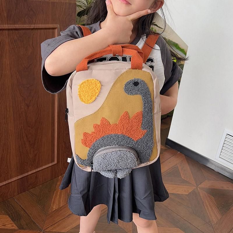 Khaki mini dinosaur backpack for kids, 21x10x26cm, with fun dinosaur design, ideal for early learners and daily outings.