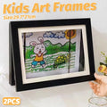 Set of two black wooden art display frames for kids' artwork, ideal for storing and showcasing drawings and creative projects.