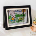 Set of two black wooden art display frames for artwork or drawings, designed for baby and kids' art and drawing storage.