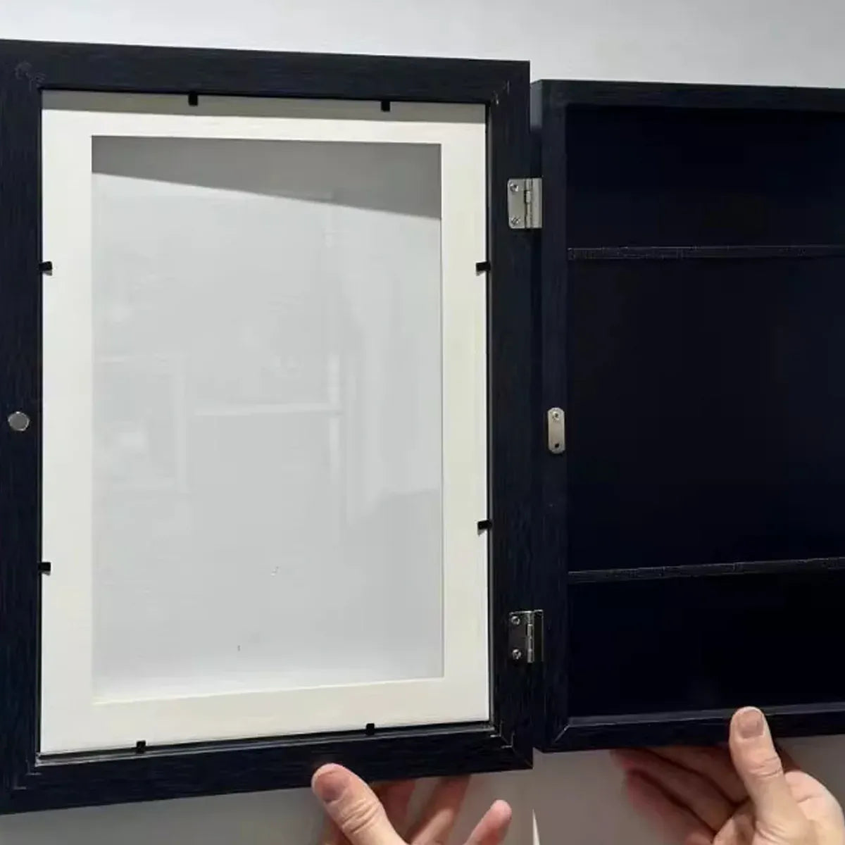 Set of two black wooden art display frames for kids' artwork, ideal for storing and showcasing drawings and creative projects.