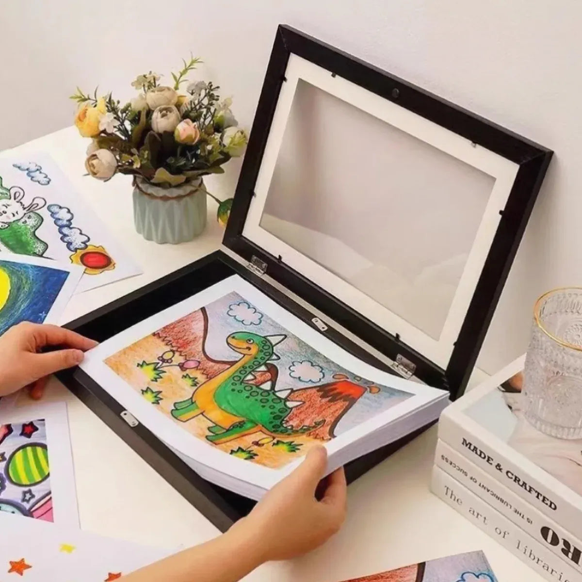 Set of two black wooden art display frames by Everything Baby for showcasing kids' artwork and drawings.