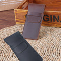 Two vintage handmade genuine leather pencil cases in cowhide, designed for kids, with protective closures and classic style.