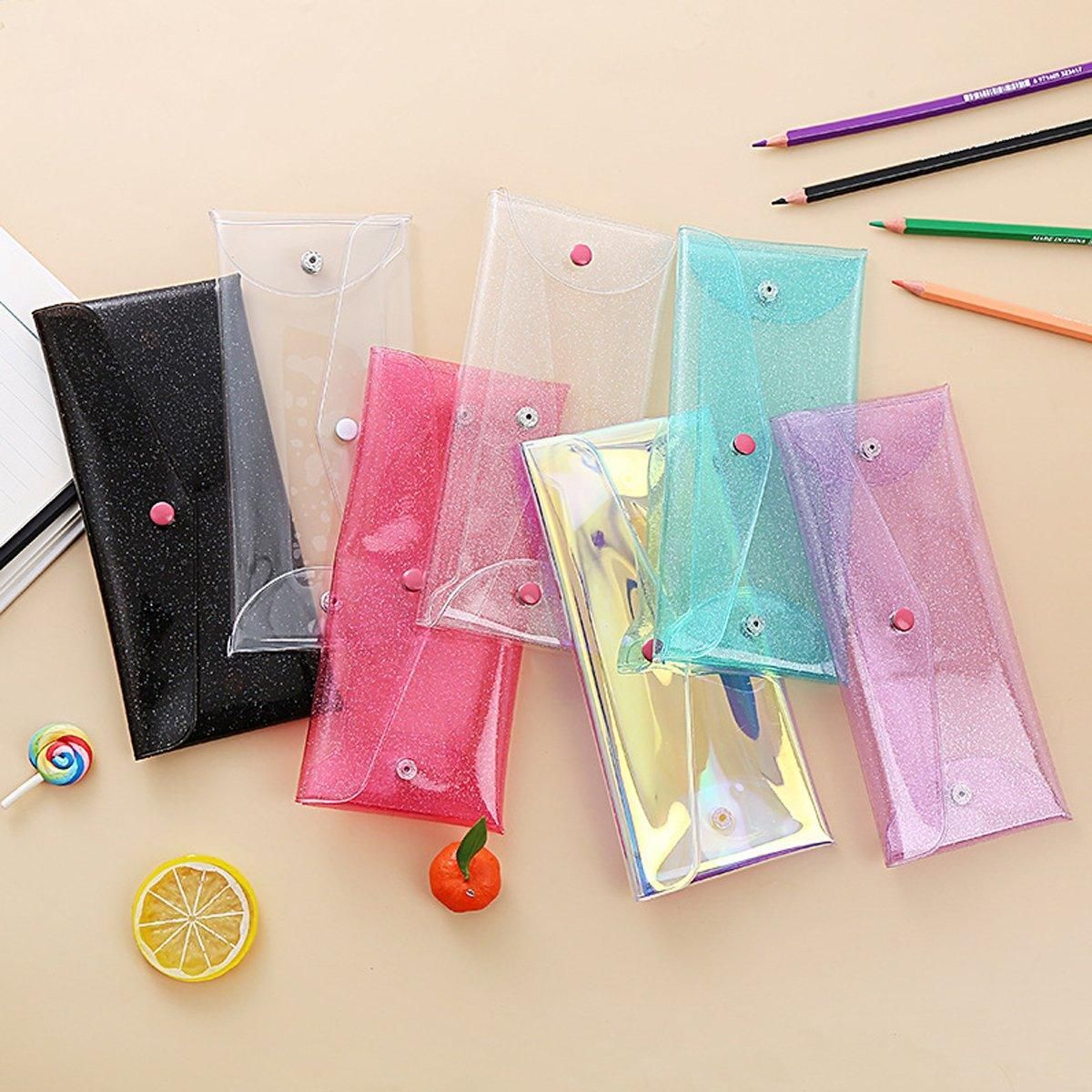Set of 7 transparent colorful pencil cases with buckle closures, portable storage bags for kids' pens and stationery from Everything Baby.