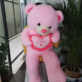Giant plush Valentines Love Bear pillow by Everything Baby, soft pink stuffed toy with heart details for kids' cuddly toy.