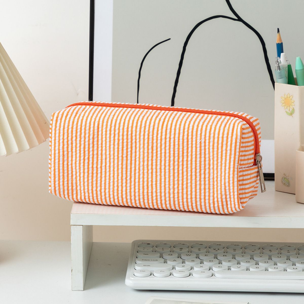 Large striped orange and white fabric pencil case with smooth zipper, ideal for pens, pencils, and desk organization.